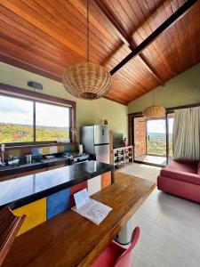 a kitchen with a table and a couch in a room at Casa do Teuler - Lapinha da Serra in Santana do Riacho