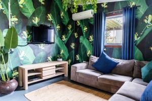 a living room with a couch and a tv at Gillys Accommodation in Camperdown