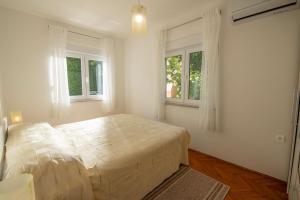 a bedroom with a large bed and two windows at House Nada 1201 in Banjole +26 photos