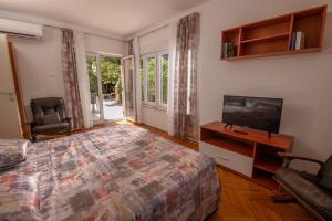 a bedroom with a bed and a flat screen tv at House Nada 1201 in Banjole
