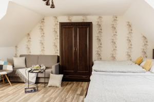 a bedroom with two beds and a couch at Villa Rustica in Bešeňová +53 photos