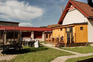 a house that is being built with a table in the yard at Villa Rustica in Bešeňová