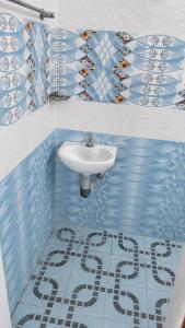 a blue and white bathroom with a sink at Hotel Sabareesh Kanyakumari in Golden Rock