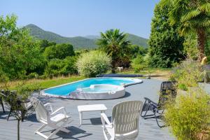 a patio with chairs and a swimming pool at Gite L'Aventura in Régades
