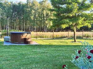 a park with a bench in the grass at Brzozowa Polanka II in Lipowiec Stary