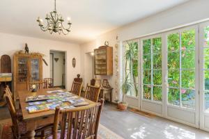 a dining room with a table and some windows at Gite L'Aventura in Régades +15 photos