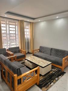 a living room with two couches and a coffee table at Nalim bliss garden in Ruiru +2 photos