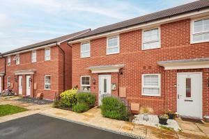 a red brick house with white doors and a driveway at Host & Stay - Fells Paddock in Bedford