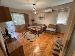 a living room with a couch and a table at Dada Lux in Kumanovo
