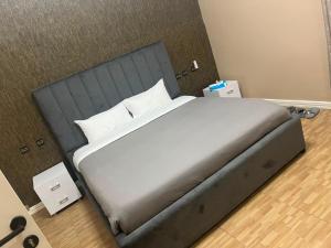 a bedroom with a large bed with white sheets and pillows at EDEN PALACE KIGALI AIRPORT AND APARTMENTs in Kigali +16 photos