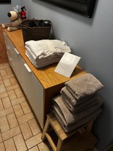 a pile of towels sitting on top of a counter at Comfortable stay near Gothenburg with private sauna and coast nearby in Billdal +20 photos