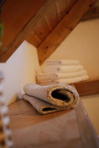 a stack of white towels on a shelf in a attic at Casa de Piatra in Porumbacu de Sus +24 photos