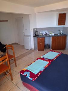 a kitchen with a table with two mats on it at Apartments Petrovic in Krimovice +24 photos
