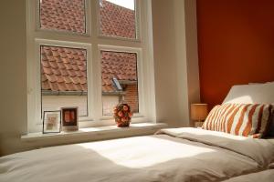 a bedroom with a bed and a window with a view at B&B Bistro Lochem in Lochem