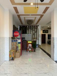 a cocacola store with a coke sign in a lobby at Hotel Bros in Ho Chi Minh City