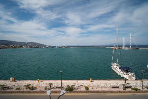 a boat is docked in a large body of water at Perla Port Suites in Chios
