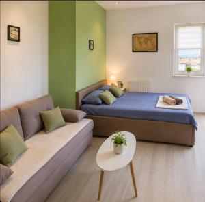 a bedroom with a bed and a couch at Villa Jovan Gevgelija in Gevgelija