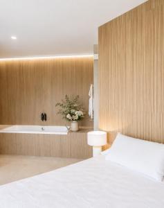 a bedroom with a bed and a bath tub at Hotel Condestable Iranzo in Jaén