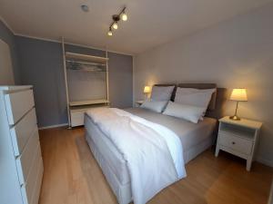 a bedroom with a large white bed and a window at Freds Ferienwohnung in Kelheim