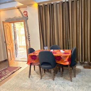 a dining room with a table and chairs at Studio near airport in Cairo