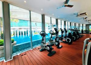 a gym with treadmills and ellipticals in a building at Vortex suites klcc by ARICA in Kuala Lumpur
