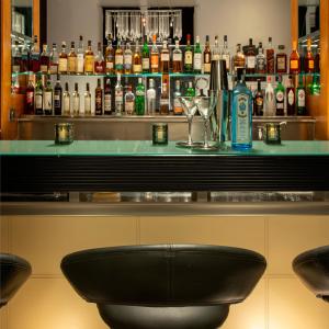 a bar with a black seat at a bar at Rocpool Reserve Hotel in Inverness