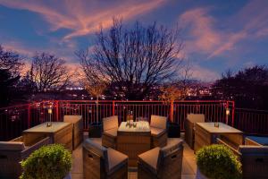a patio with a table and chairs on a balcony at Rocpool Reserve Hotel in Inverness