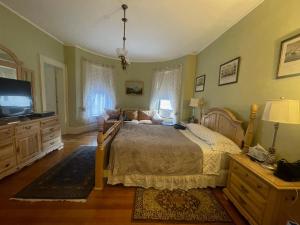 a bedroom with a bed and a flat screen tv at Fenway Park Brownstone in Boston +9 photos