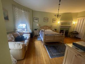 a living room with a bed and a couch at Fenway Park Brownstone in Boston