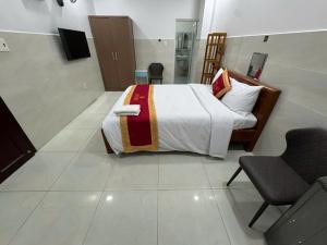 a bedroom with a bed and a chair in it at Hotel Bros in Ho Chi Minh City +21 photos