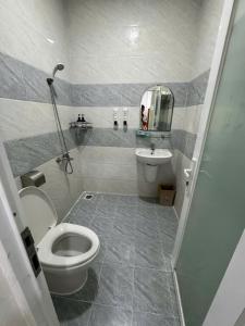 a bathroom with a toilet and a sink at Hotel Bros in Ho Chi Minh City