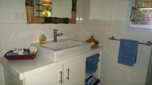 a white bathroom with a sink and a mirror at Palmerston Sunset Retreat in Palmerston +15 photos