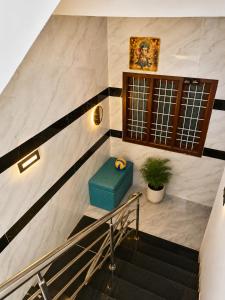 a staircase with a blue stool in a building at CG Blue Horizon Villa in Vellore