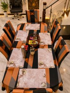 a table with chairs and a table cloth on it at CG Blue Horizon Villa in Vellore