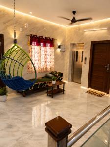a living room with a couch and a net at CG Blue Horizon Villa in Vellore +12 photos