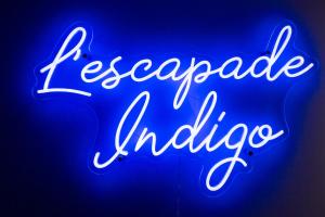 a neon sign that readsrecaprocal indigo at L'Escapade Indigo - Balnéo - Sauna in Tournefeuille +56 photos