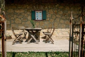 a table and chairs in front of a building with a window at Weingut Bleyweis in Kitzeck im Sausal