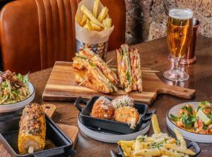 a table topped with plates of food and french fries at The Grand Olive Aero Suites Near Delhi Airport in New Delhi