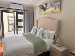 a bedroom with a bed and a window at Cathy & P Guesthouse in Hartbeespoort +22 photos