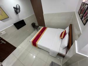 a small room with a bed and a television at Hotel Bros in Ho Chi Minh City
