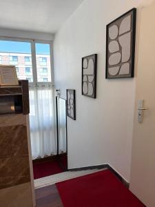 a room with two pictures on the wall and a door at Hotel Wandsbek Hamburg in Hamburg