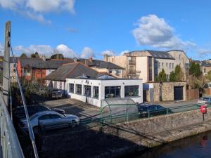 a white building with cars parked in a parking lot at The Bridge in Ballyconnell