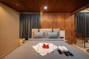 a bedroom with a bed with a red bow on it at Hotel Rism Suites Koramangala in Bangalore
