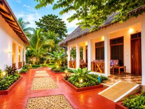 a courtyard of a house with trees and plants at Tumaini Bungalows in Nungwi