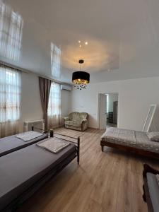 a large room with two beds and a couch at Casa Bianca Kobuleti in Kobuleti