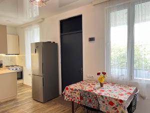 a kitchen with a table and a refrigerator at Casa Bianca Kobuleti in Kobuleti +22 photos