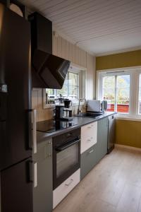 a kitchen with a refrigerator and a stove top oven at Aurland Guesthouse in Aurland +12 photos