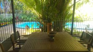 a table with a vase sitting on it on a patio at Palmerston Sunset Retreat in Palmerston