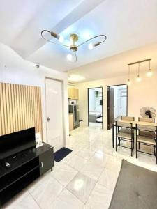 a living room with a table and a dining room at Lis Urban Residence in Manila