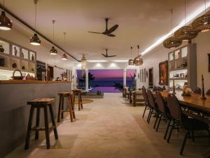 a restaurant with tables and chairs and a view of the ocean at beacfront villa claudius ,michamvi in Michamvi
